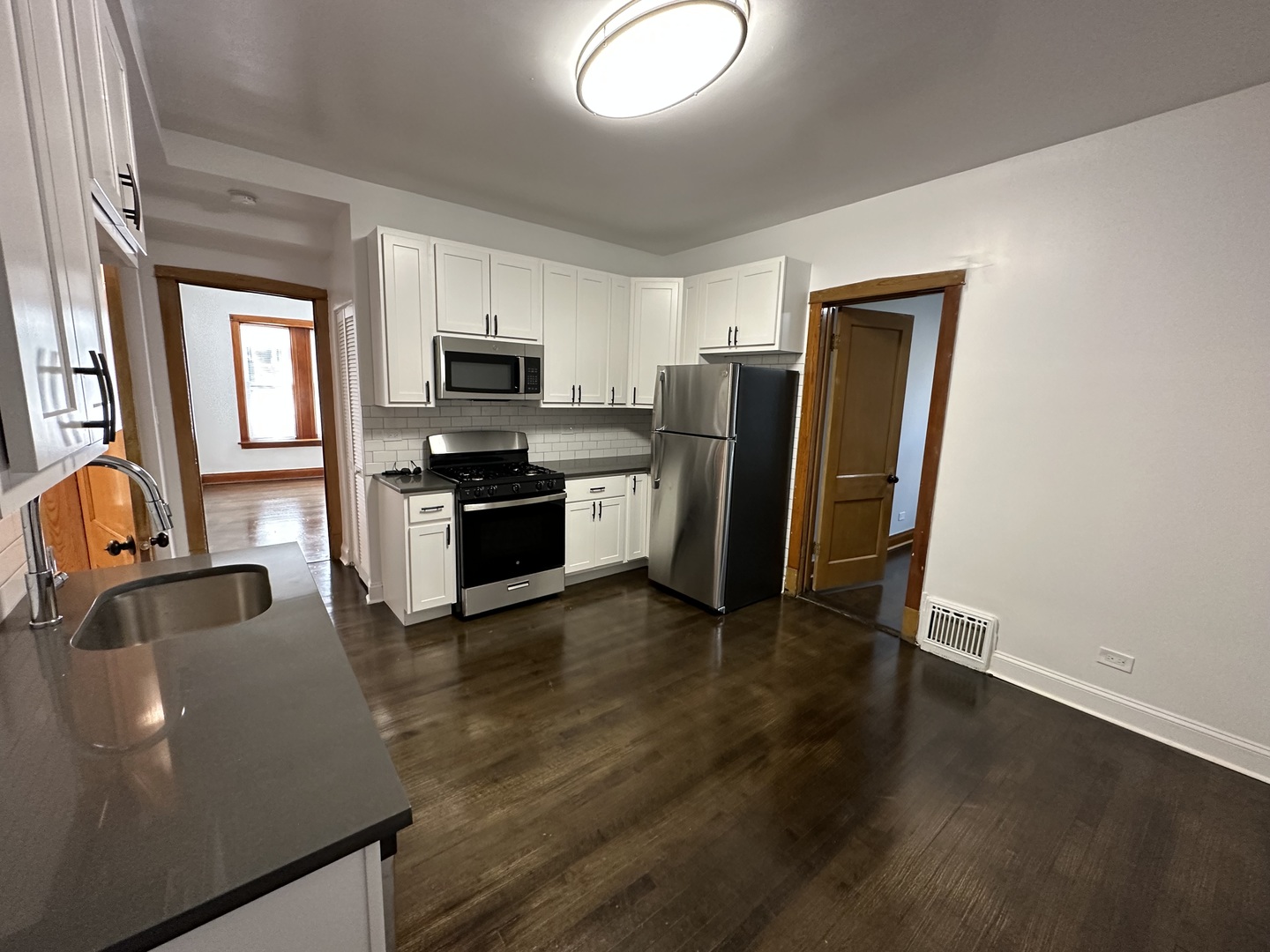 Undisclosed Address Chicago, IL 60618 - Photo 13 of 16 a kitchen with stainless steel appliances granite countertop a refrigerator a stove top oven a sink and dishwasher