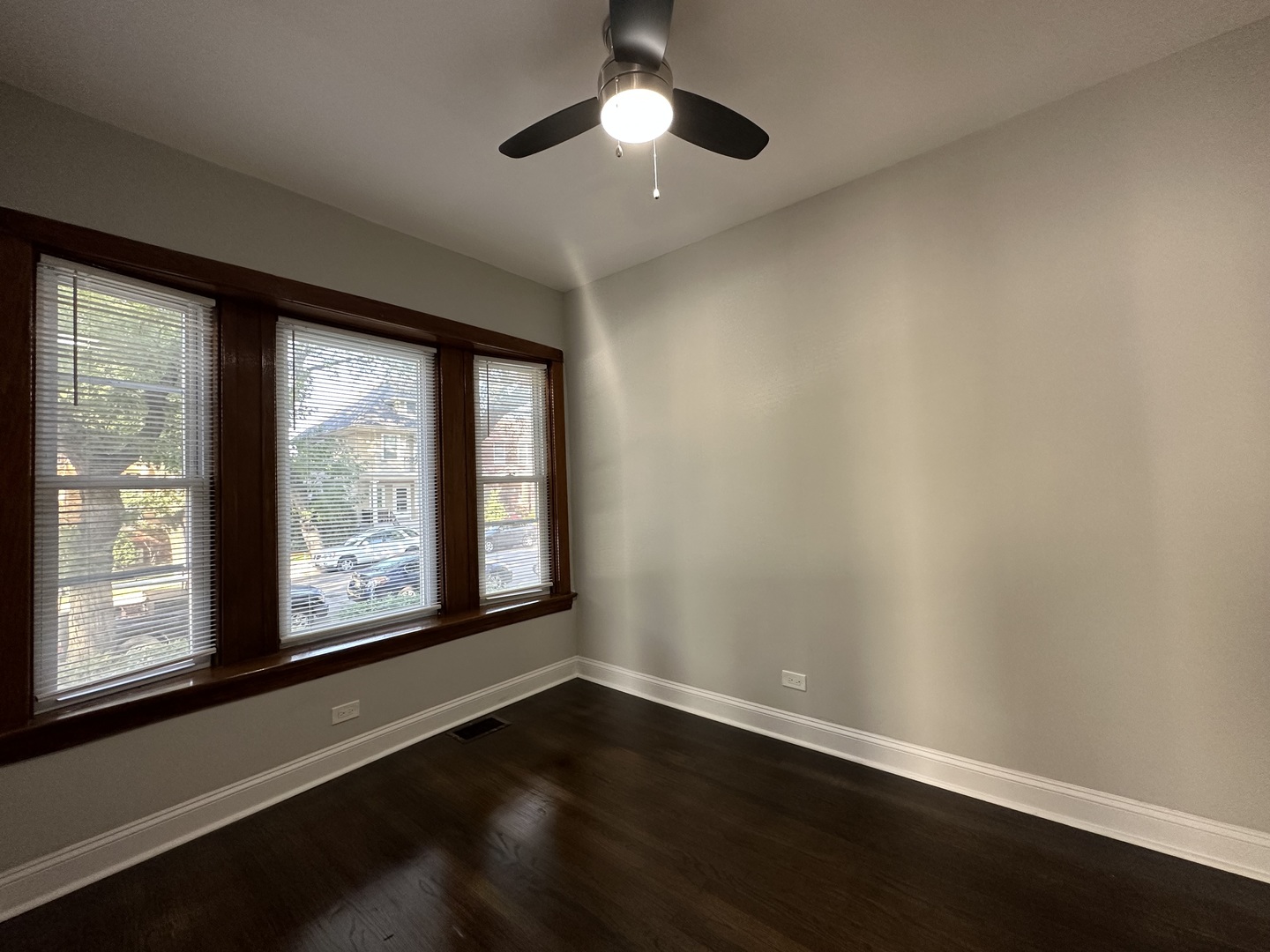 Undisclosed Address Chicago, IL 60618 - Photo 6 of 16 a view of an empty room with wooden floor and a window