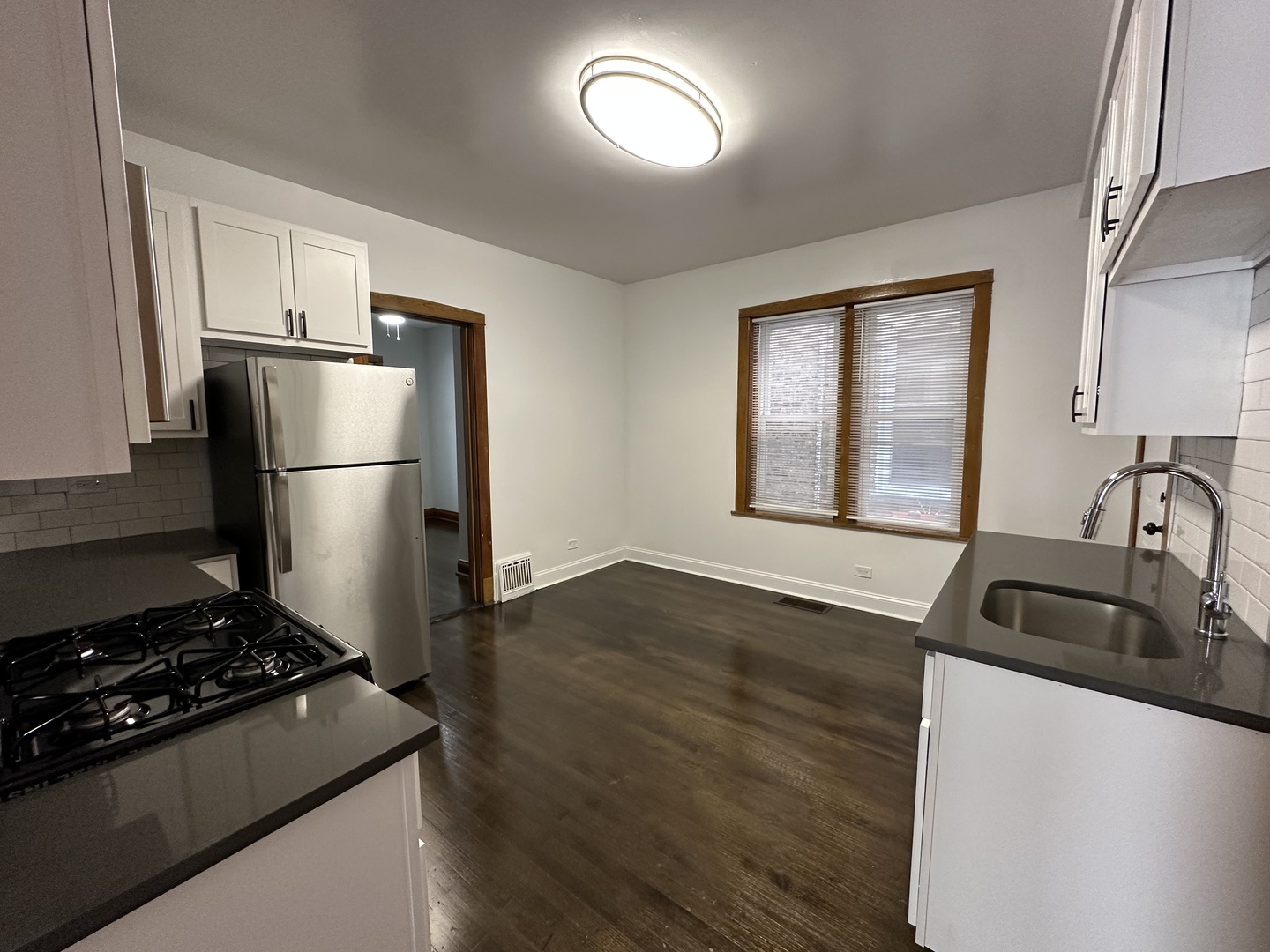 Undisclosed Address Chicago, IL 60618 - Photo 10 of 16 a kitchen with a refrigerator and a sink