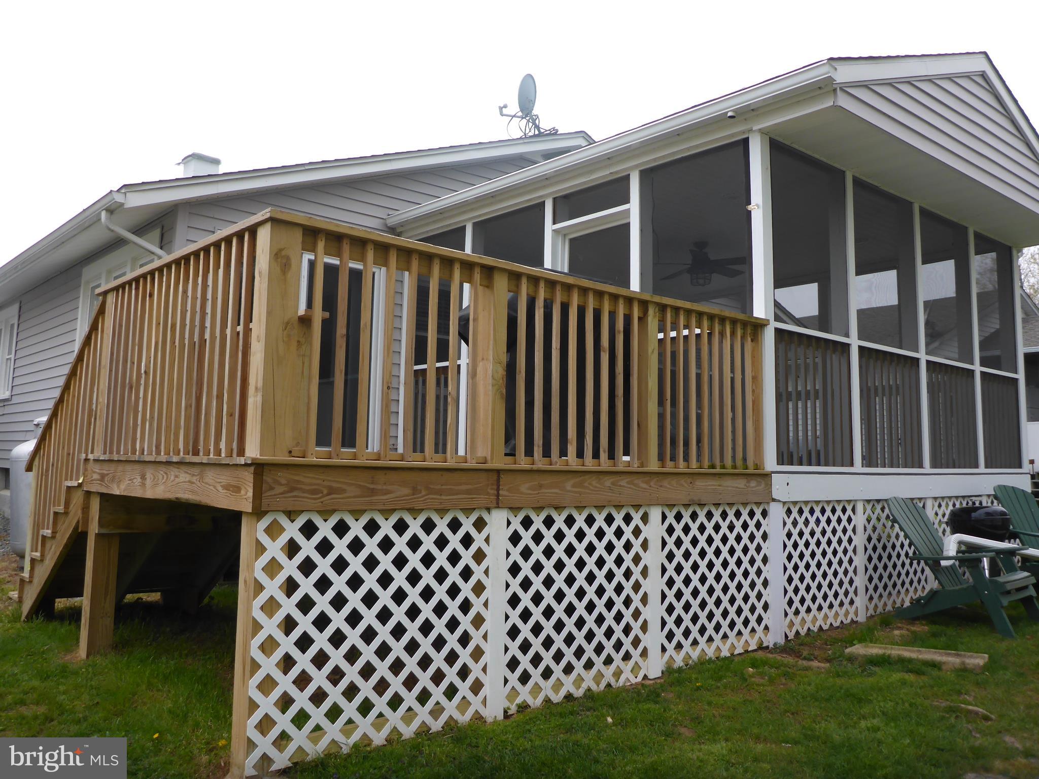 Screened in crab porch and adjoining BBQ deck.