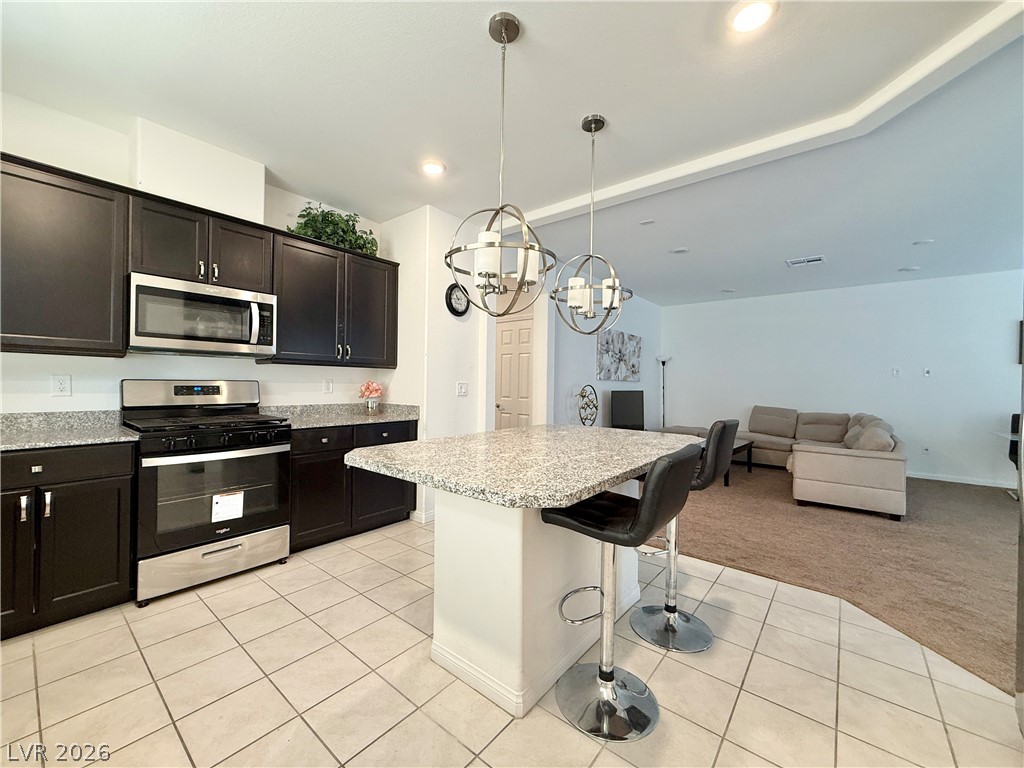 7777 South Westwind Road Las Vegas, NV 89139 - Photo 27 of 46 An inviting open-concept kitchen flows into the living area, perfect for modern living.