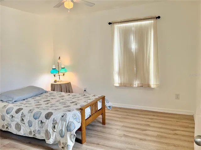 a bathroom with a granite countertop sink toilet and a mirror