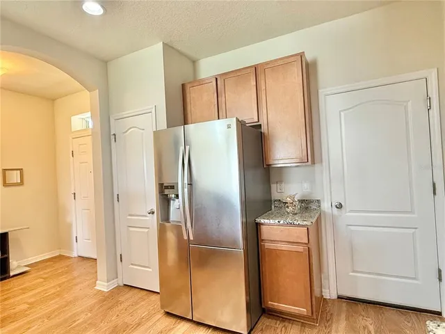a kitchen with stainless steel appliances a refrigerator sink and cabinets