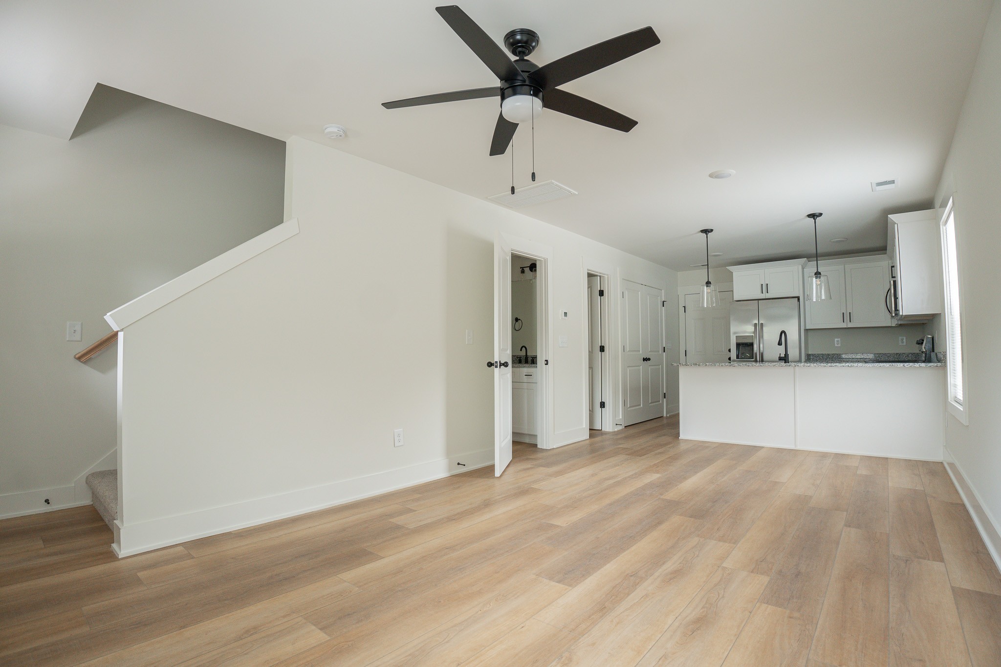 a view of a kitchen with a sink and a refrigerator
