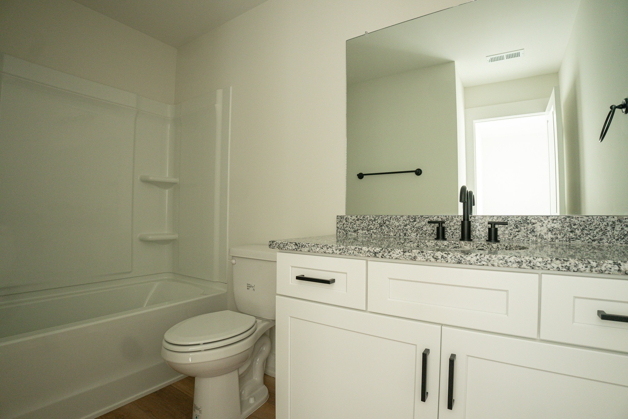 114 Wix Avenue, Unit B Portland, TN 37148 - Photo 9 of 13 a bathroom with a granite countertop toilet sink and mirror
