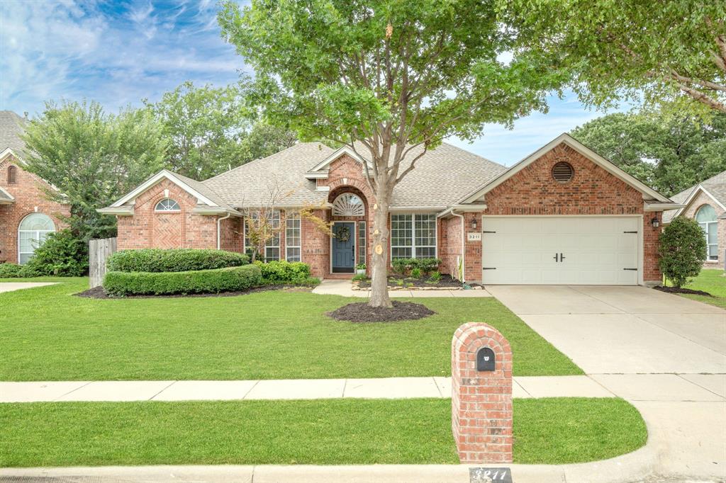 a front view of a house with a yard garage and outdoor seating