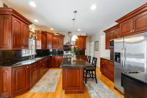 a kitchen with granite countertop lots of counter top space and stainless steel appliances