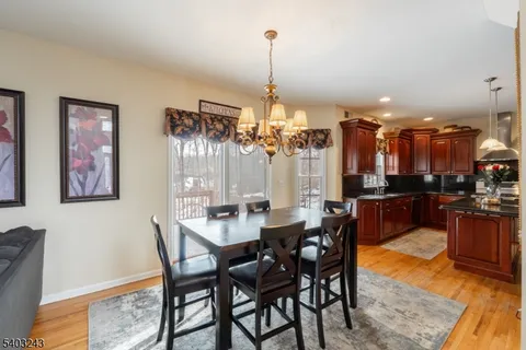 a dining room with furniture a chandelier and window