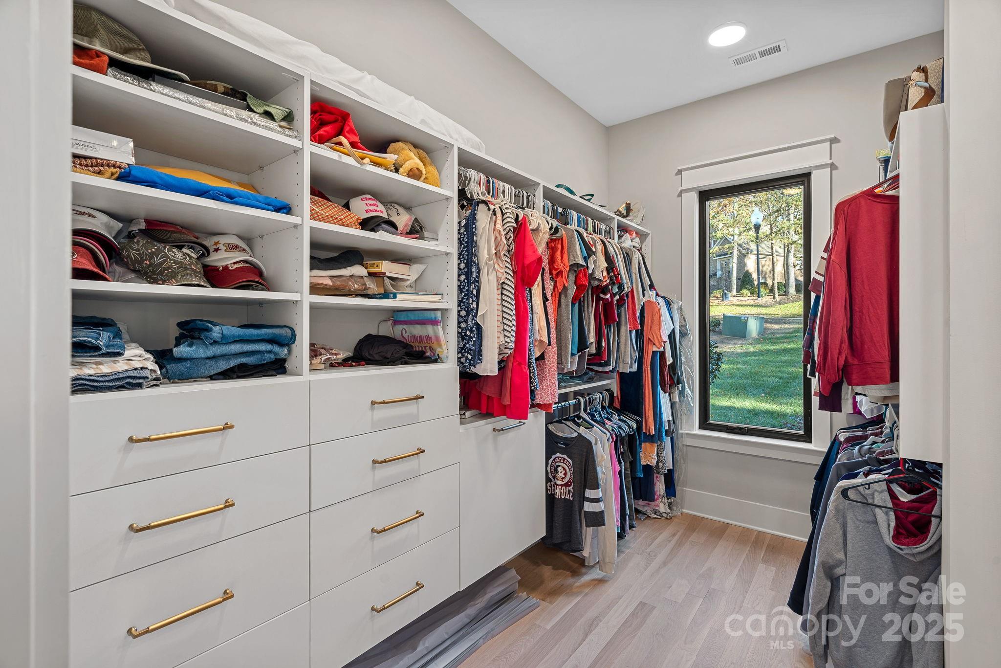162 West Maranta Road Mooresville, NC 28117 - Photo 19 of 46 a view of walk in closet with clothes and shoes