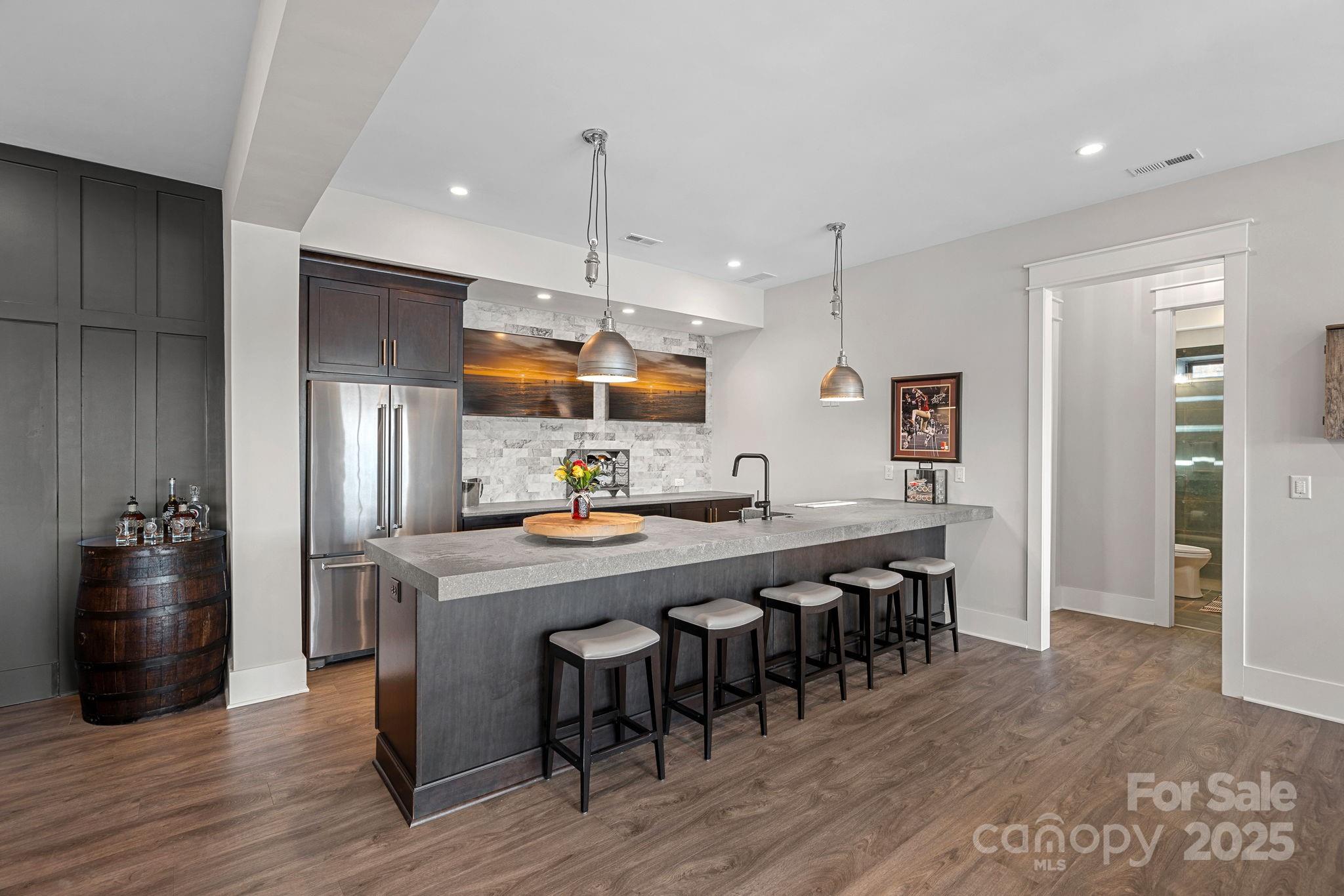 162 West Maranta Road Mooresville, NC 28117 - Photo 25 of 46 a kitchen with stainless steel appliances a dining table chairs stove and refrigerator