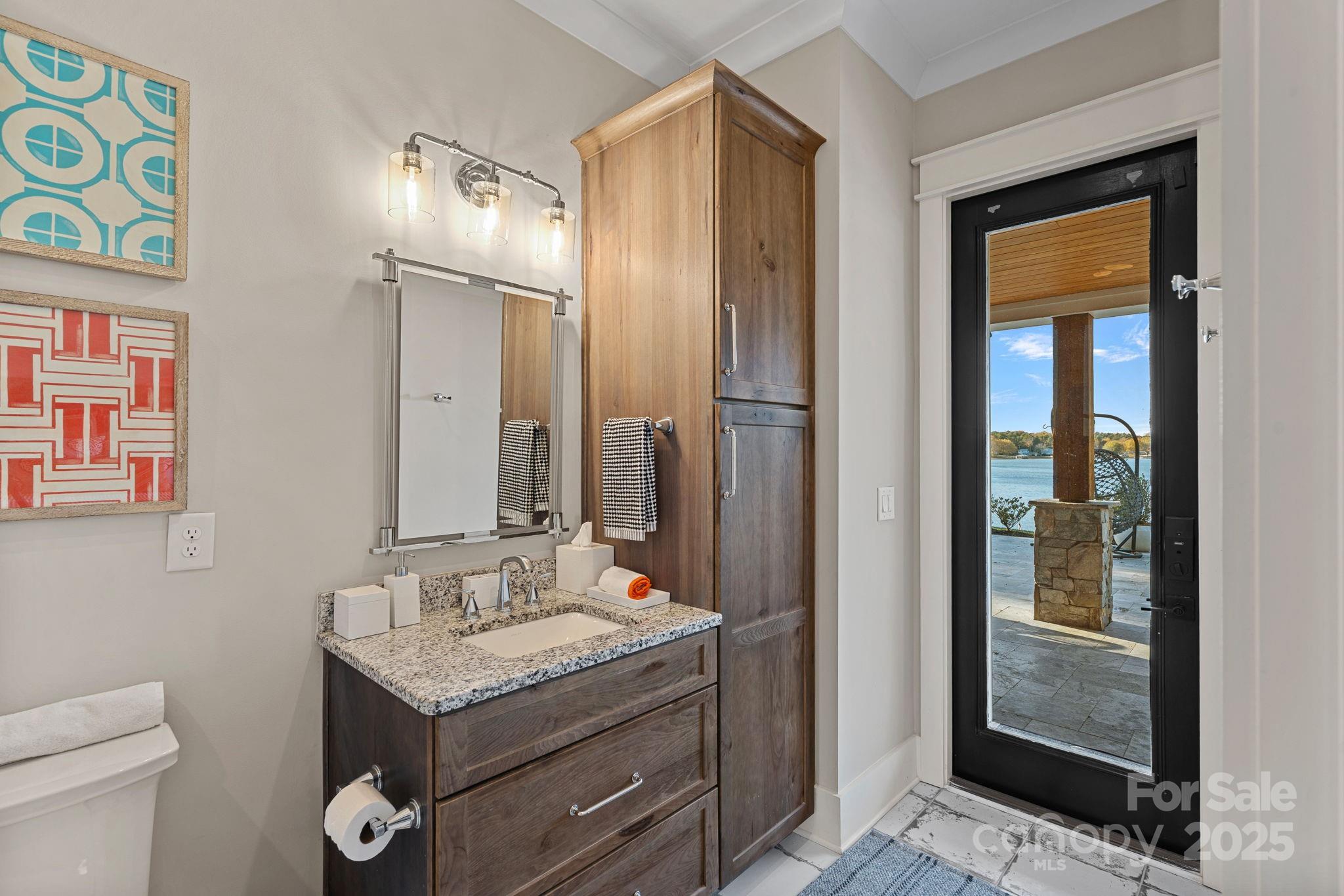 162 West Maranta Road Mooresville, NC 28117 - Photo 32 of 46 a bathroom with a granite countertop sink a toilet and shower