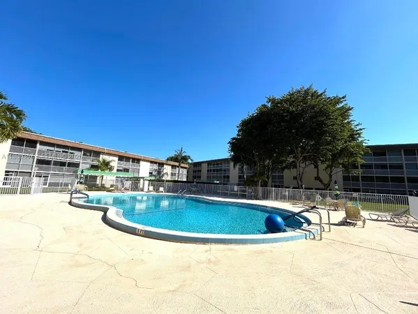 a view of a swimming pool with an outdoor seating and a balcony