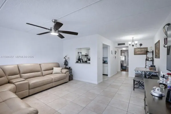 a living room with furniture and kitchen view