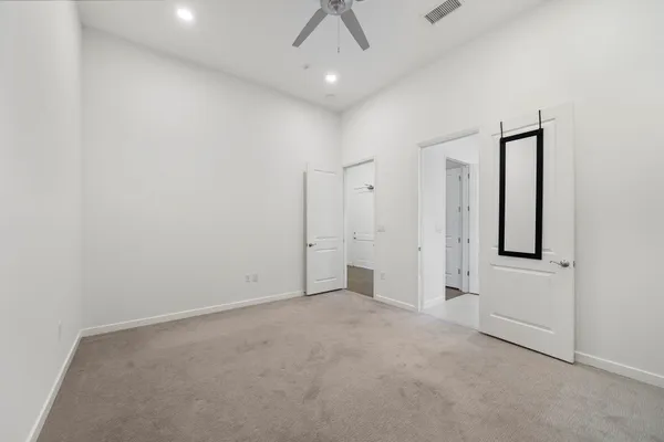an empty room with chandelier fan