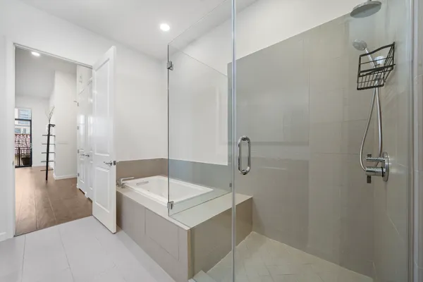 a bathroom with a tub a sink and a shower