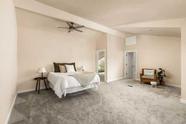 a bathroom with a toilet a sink a mirror and a window