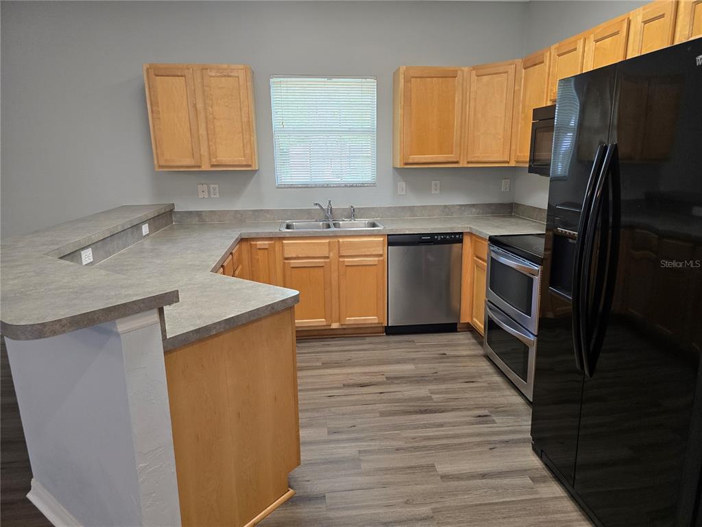 7976 48 Way Gainesville, FL 32653 - Photo 5 of 26 a kitchen with stainless steel appliances granite countertop a sink stove and refrigerator