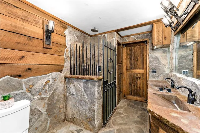 a bathroom with a sink toilet and shower