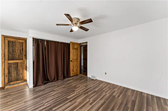 a view of a livingroom with wooden floor and closet area