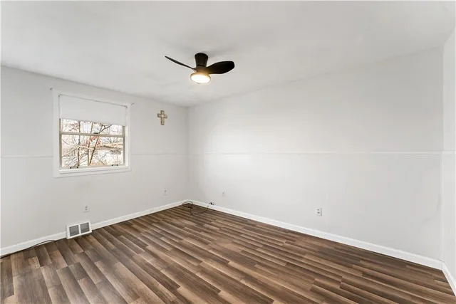 a view of a room with wooden floor and natural light