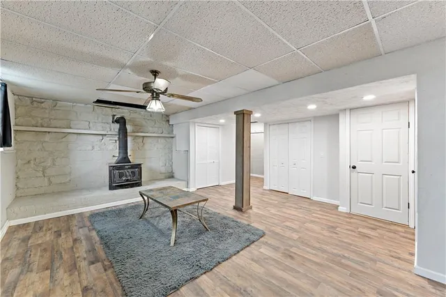 a view of a hallway with wooden floor and furniture