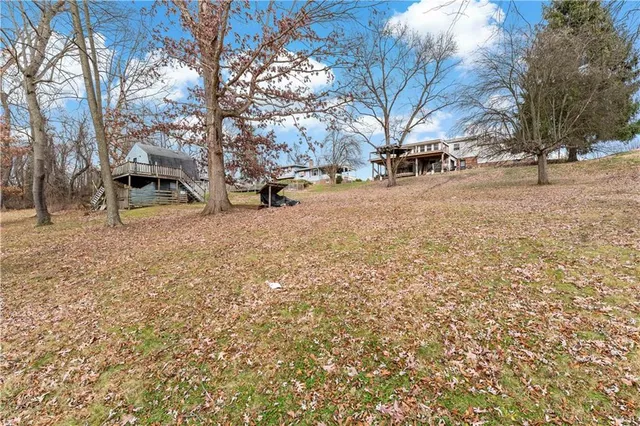 a view of a house with a yard and sitting area