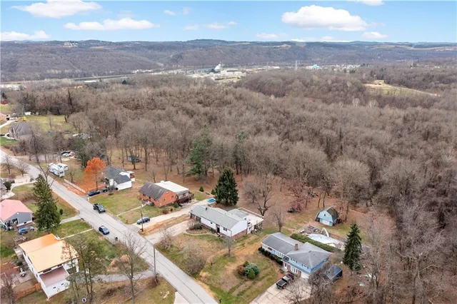 an aerial view of residential houses with outdoor space