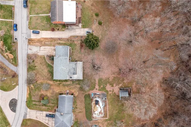 an aerial view of a house with yard