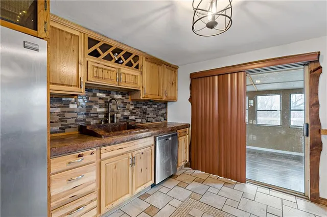 a kitchen with stainless steel appliances granite countertop a sink and cabinets