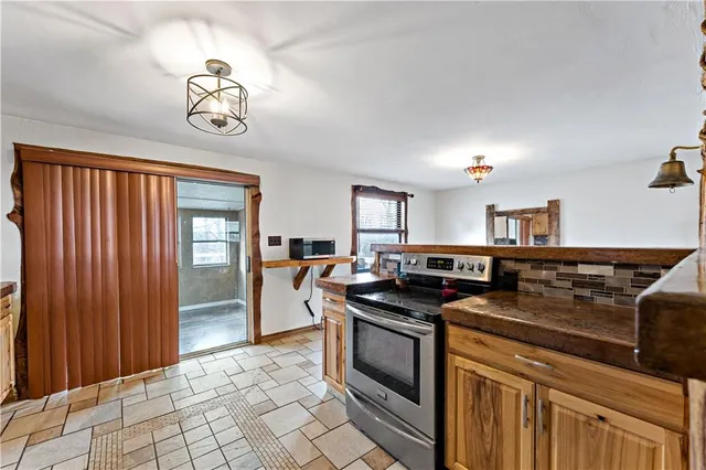 a kitchen with stainless steel appliances granite countertop a stove and a sink