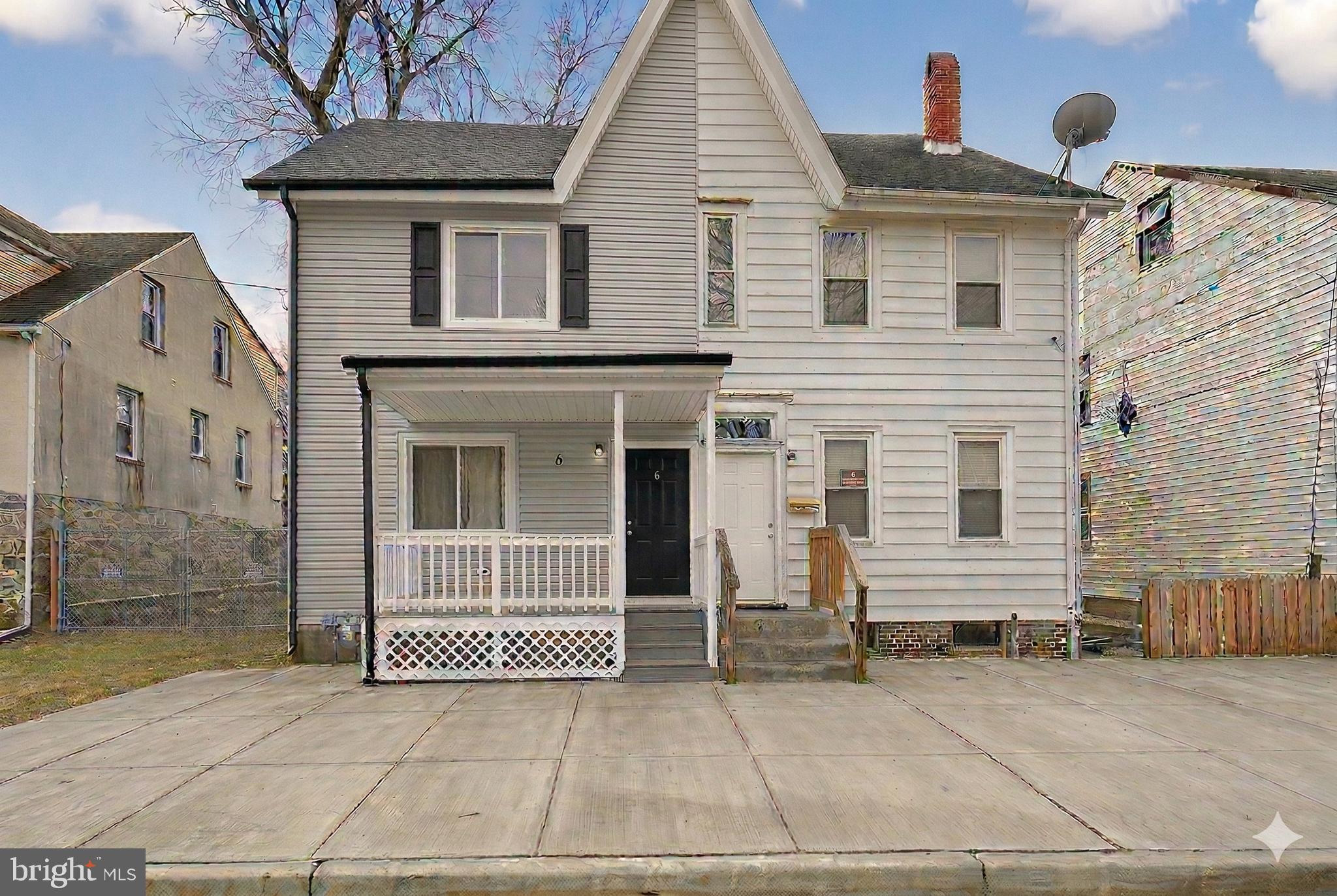 a view of a house with a door and a yard