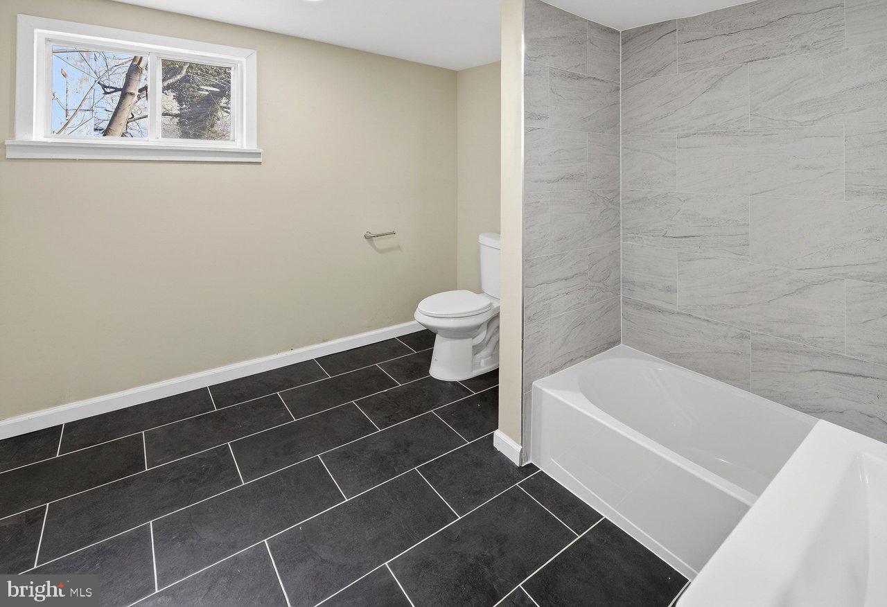 6 Olive Street Salem, NJ 08079 - Photo 13 of 15 a bathroom with a toilet and a bathtub