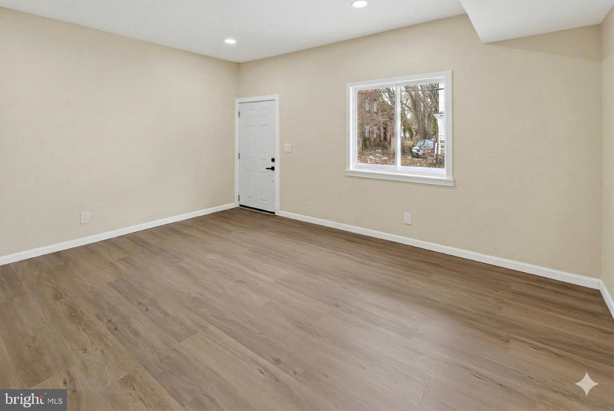 6 Olive Street Salem, NJ 08079 - Photo 3 of 15 an empty room with wooden floor and windows