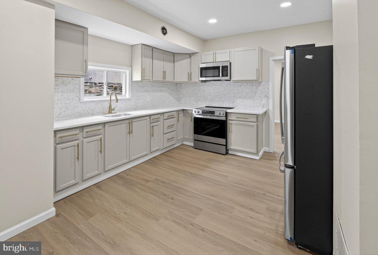 6 Olive Street Salem, NJ 08079 - Photo 5 of 15 a kitchen with granite countertop a refrigerator stove top oven and sink