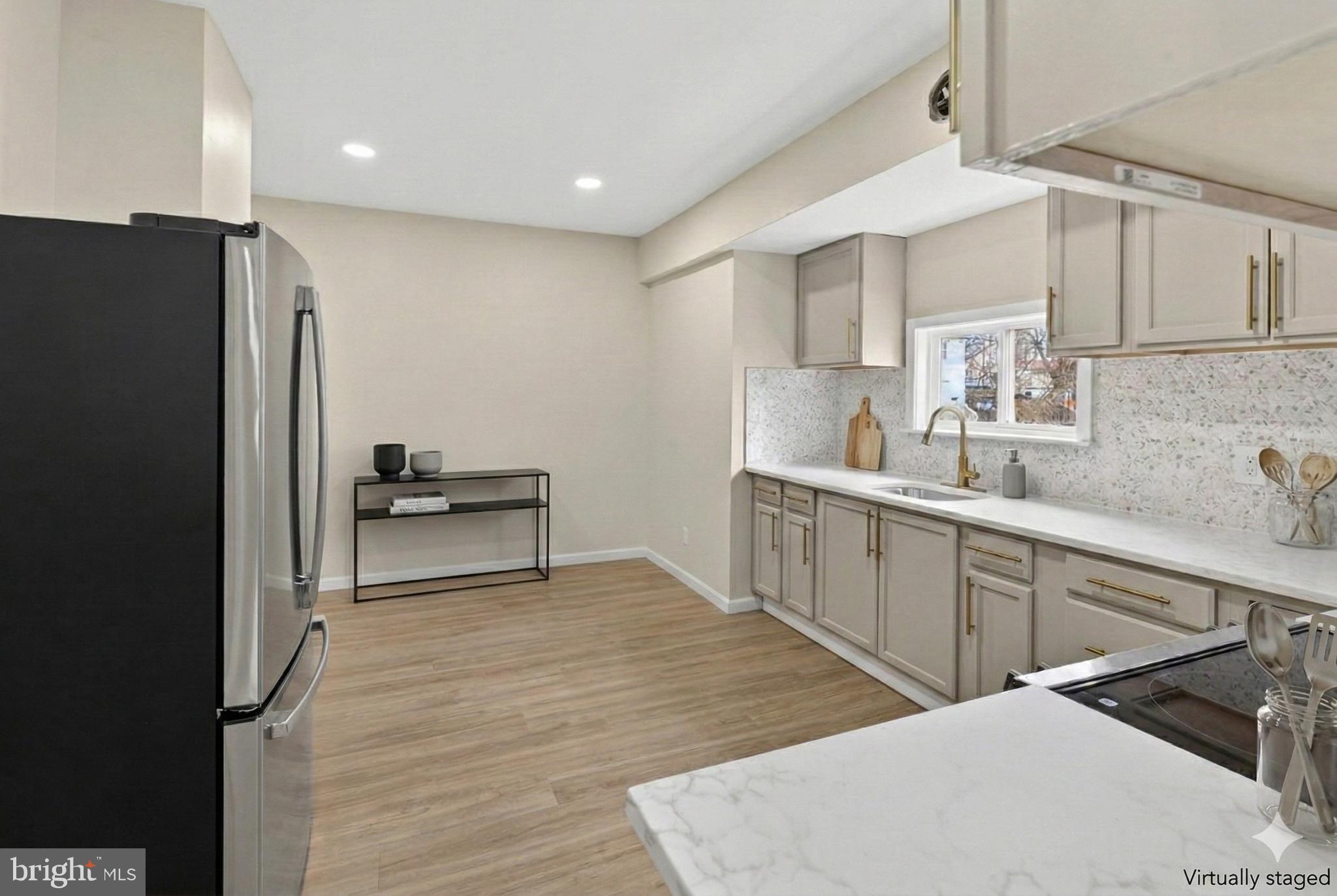 6 Olive Street Salem, NJ 08079 - Photo 6 of 15 a kitchen with stainless steel appliances cabinets a sink and a refrigerator