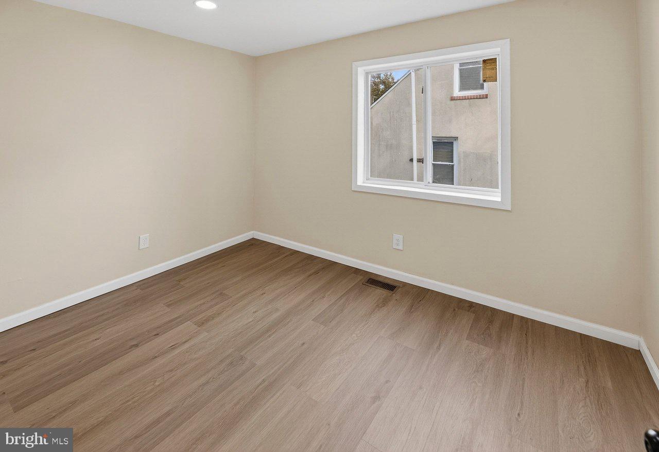 6 Olive Street Salem, NJ 08079 - Photo 10 of 15 a view of an empty room with wooden floor and a window