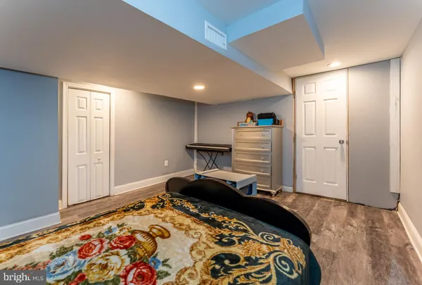 a bedroom with bed and wooden floor