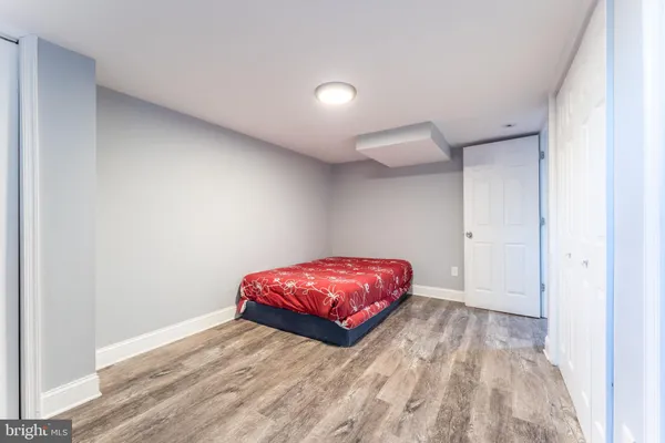 a bedroom with a bed and a potted plant