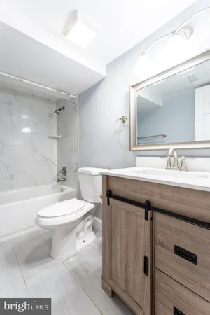 a bathroom with a sink a toilet and a mirror