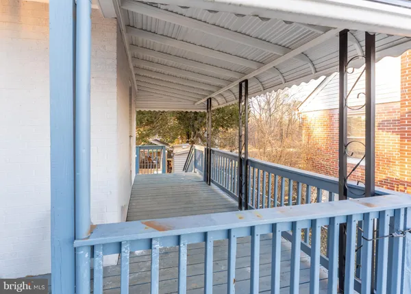 a view of porch with wooden floor