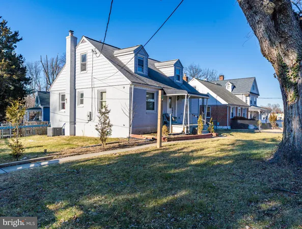 a view of a house with a big yard and large trees