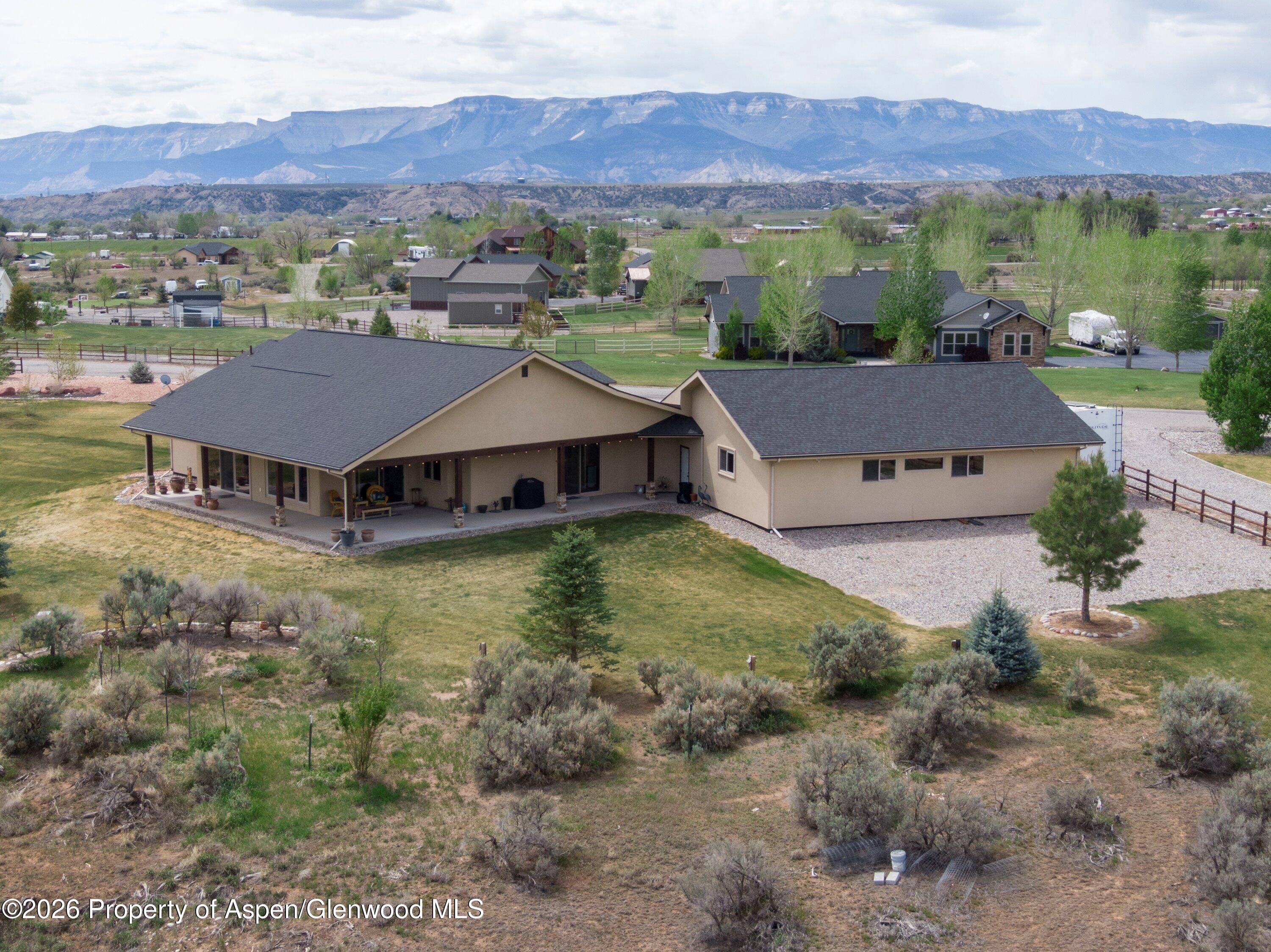265 South Meadow Drive Rifle, CO 81650 - Photo 21 of 76 an aerial view of a house with a mountain in the background