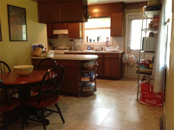897 Point Road Marion, MA 02738 - Photo 3 of 8 a kitchen with a sink a stove a dining table and chairs