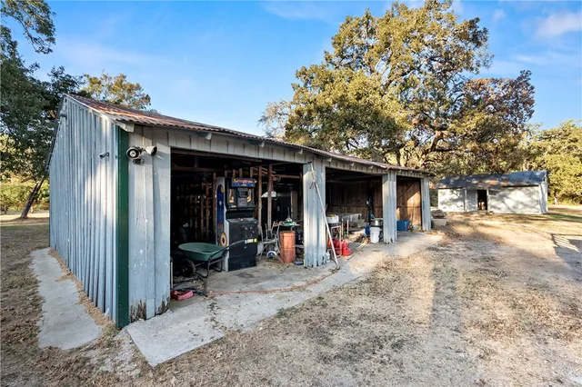 a view of a house with a yard and tree