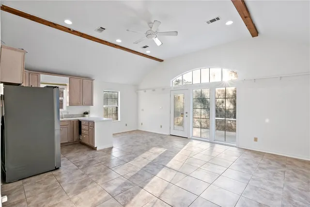 a kitchen with refrigerator and window