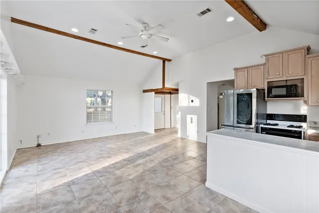 a kitchen with stainless steel appliances granite countertop a refrigerator sink and cabinets