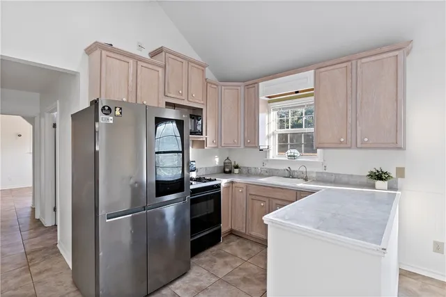 an empty room with windows and ceiling fan
