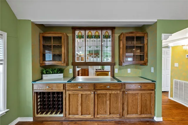 a view of an empty room with a fireplace and a window