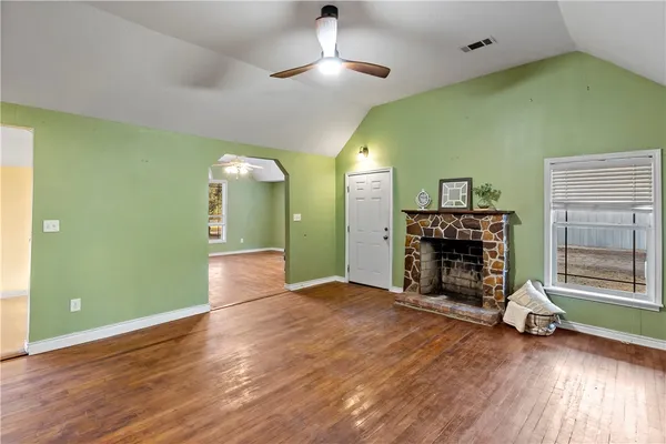 a kitchen with stainless steel appliances granite countertop a stove refrigerator and a sink