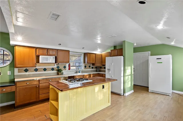 a kitchen with stainless steel appliances granite countertop a stove and a refrigerator